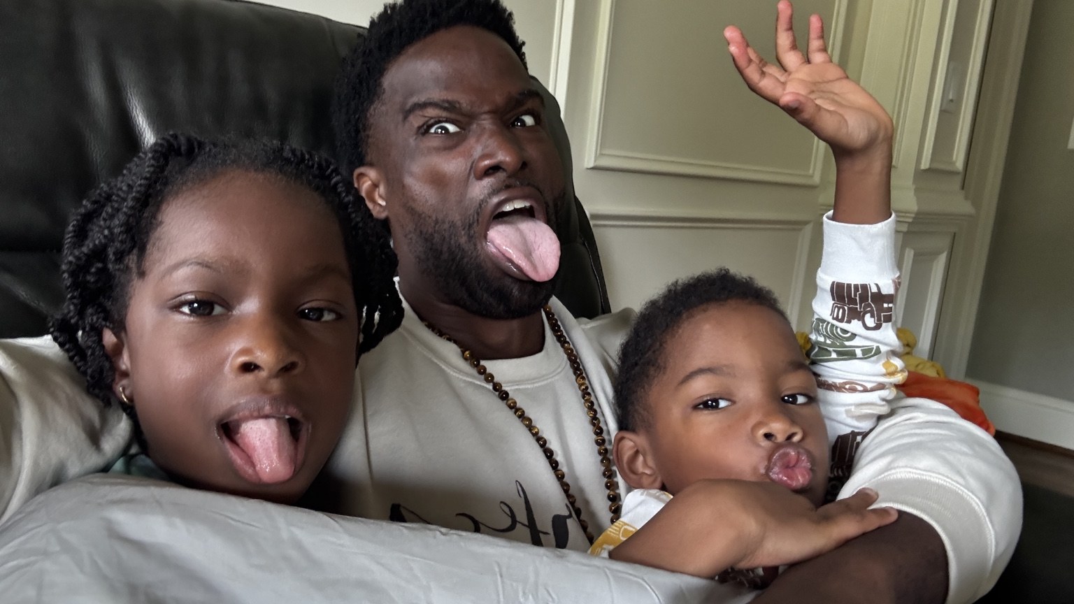 Phil BeLight making silly faces with his children